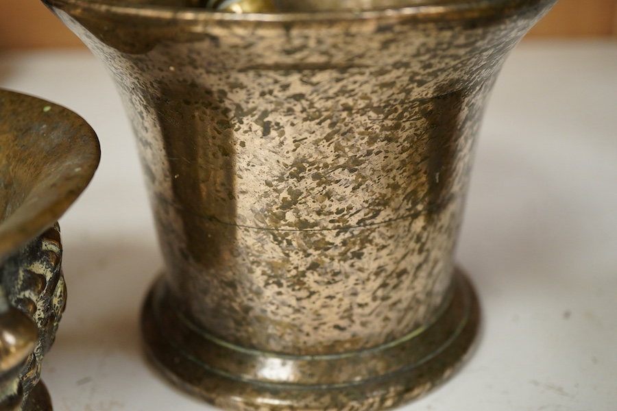 A bronze pestle and mortar, and one other mortar decorated in relief, 18cm in length